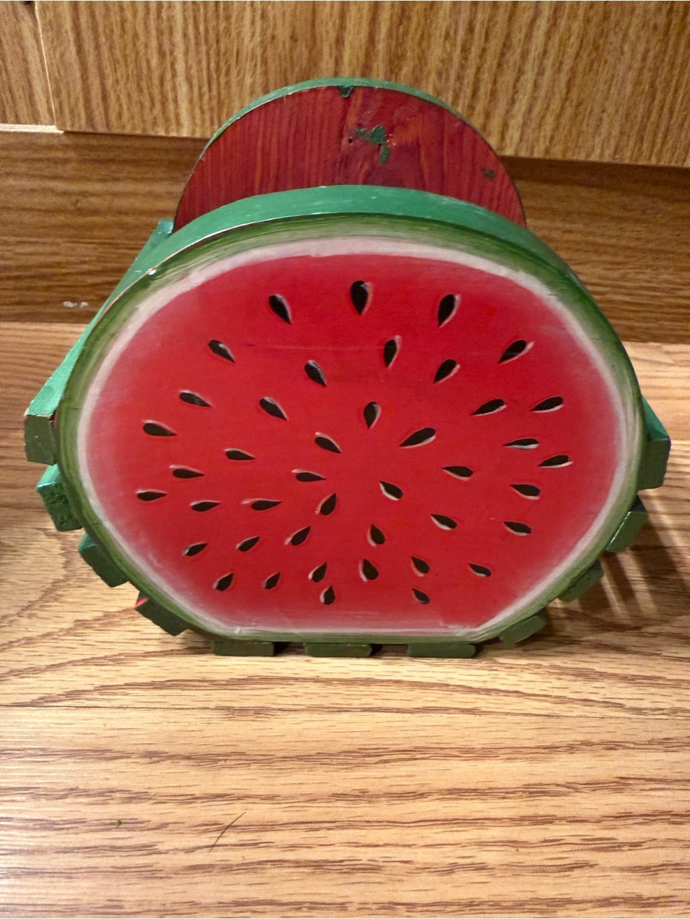 A vintage wooden watermelon-themed slat hand painted basket, 1995’